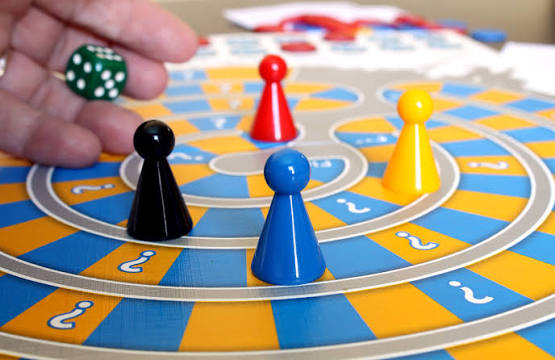 board-game-with-pieces-on-yellow-and-blue-checkered-board
